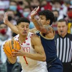
              Wisconsin's Johnny Davis (1) drives against Michigan's Eli Brooks (55) during the first half of an NCAA college basketball game Sunday, Feb. 20, 2022, in Madison, Wis. (AP Photo/Andy Manis)
            