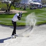 
              Sahith Theegala hits the lip of the bunker with his shot on the second hole during the third round of the Phoenix Open golf tournament Saturday, Feb. 12, 2022, in Scottsdale, Ariz. (AP Photo/Darryl Webb)
            