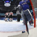 
              United States goalkeeper Maddie Rooney (35) pulls the puck out of the net as Canada players celebrate after a goal during a preliminary round women's hockey game at the 2022 Winter Olympics, Tuesday, Feb. 8, 2022, in Beijing. (Jonathan Ernst/Pool Photo via AP)
            