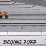 
              Workers clean spectators' seats at the ski jumping stadium ahead of the 2022 Winter Olympics, Tuesday, Feb. 1, 2022, in Zhangjiakou, China. (AP Photo/Matthias Schrader)
            