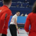 
              John Morris, of Canada, center, looks towards the players of Britain during the mixed doubles curling match at the Beijing Winter Olympics Thursday, Feb. 3, 2022, in Beijing. (AP Photo/Brynn Anderson)
            