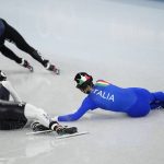 
              Kristen Santos of the United States, and Arianna Fontana of Italy, crash in the final of the women's 1000-meters during the short track speedskating competition at the 2022 Winter Olympics, Friday, Feb. 11, 2022, in Beijing. (AP Photo/Bernat Armangue)
            