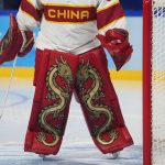 
              Dragons decorate the pads of China goalkeeper Zhou Jiaying during a preliminary round women's hockey game between China and Denmark at the 2022 Winter Olympics, Friday, Feb. 4, 2022, in Beijing. (AP Photo/Petr David Josek)
            