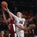 
              Oregon State's Ellie Mack (20) and Stanford's Lexie Hull (12) and Kiki Iriafen (44) reach for a rebound during the first half of an NCAA college basketball game in Corvallis, Ore., Friday, Feb. 18, 2022. (AP Photo/Amanda Loman)
            
