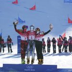 
              From left, silver medalist Austria's Daniela Ulbing, gold medalist Czech Republic's Ester Ledecka and bronze medalist Slovenia's Gloria Kotnik celebrate during the venue ceremony for the women's parallel giant slalom at the 2022 Winter Olympics, Tuesday, Feb. 8, 2022, in Zhangjiakou, China. (AP Photo/Gregory Bull)
            