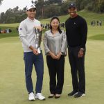
              Joaquin Niemann, left, of Chile, poses with his trophy next to Megan Watanabe, center, president of The Riviera Country Club, and Tiger Woods, right, on the 18th green after winning the Genesis Invitational golf tournament at Riviera Country Club, Sunday, Feb. 20, 2022, in the Pacific Palisades area of Los Angeles. (AP Photo/Ryan Kang)
            