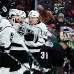 
              Los Angeles Kings left wing Viktor Arvidsson (33) celebrates his goal against Arizona Coyotes goaltender Scott Wedgewood (31) with Kings centers Phillip Danault (24) and Trevor Moore (12) during the second period of an NHL hockey game Wednesday, Feb. 23, 2022, in Glendale, Ariz. (AP Photo/Ross D. Franklin)
            
