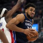 
              Minnesota Timberwolves center Karl-Anthony Towns (32) drives on Detroit Pistons forward Jerami Grant (9) in the first half of an NBA basketball game in Detroit, Thursday, Feb. 3, 2022. (AP Photo/Paul Sancya)
            