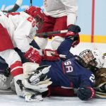 
              United States' Dani Cameranesi (24) and Russian Olympic Committee's Alexandra Vafina (29) pick themselves up after players ended up in a pile during a preliminary round women's hockey game at the 2022 Winter Olympics, Saturday, Feb. 5, 2022, in Beijing. (AP Photo/Petr David Josek)
            