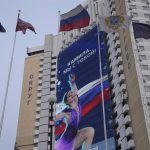 
              A huge electronic billboard shows a photo of Kamila Valieva with words "Kamila, we are with you" on the building of the Salut hotel in Moscow, Russia, Monday, Feb. 14, 2022. Russian teenager Kamila Valieva has been cleared to compete in the women's figure skating competition at the Winter Olympics despite failing a pre-Games drug test. (AP Photo/Alexander Zemlianichenko)
            