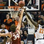 
              Oklahoma State forward Kalib Boone (22) blocks a shot by Oklahoma forward Jacob Groves (34) in the first half of an NCAA college basketball game, Saturday, Feb. 5, 2022, in Stillwater, Okla. Oklahoma State defeated rival Oklahoma 64-55. (AP Photo/Brody Schmidt)
            
