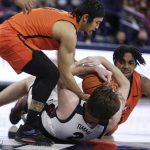 
              Pacific guard Pierre Crockrell II, left, and forward Sammy Freeman, right, go after the ball against Gonzaga forward Drew Timme during the first half of an NCAA college basketball game, Thursday, Feb. 10, 2022, in Spokane, Wash. (AP Photo/Young Kwak)
            