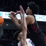 
              Rutgers forward Ron Harper Jr., right, drops the ball as he drives against Northwestern forward Pete Nance during the first half of an NCAA college basketball game in Evanston, Ill., Tuesday, Feb. 1, 2022. (AP Photo/Nam Y. Huh)
            