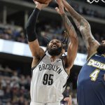 
              Brooklyn Nets guard DeAndre' Bembry, left, is fouled by Denver Nuggets center DeMarcus Cousins in the first half of an NBA basketball game, Sunday, Feb. 6, 2022, in Denver. (AP Photo/David Zalubowski)
            