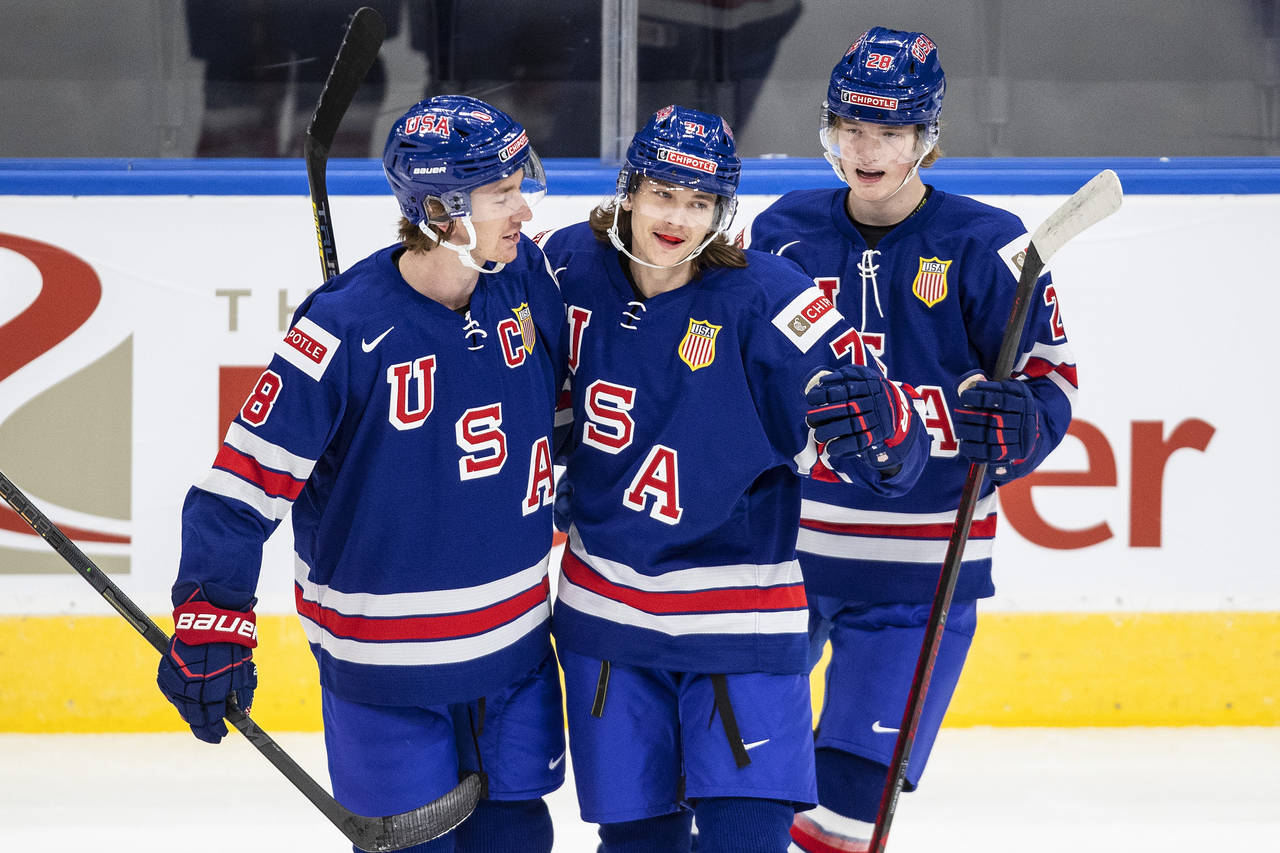 FILE - United States' Jake Sanderson, from left, Tanner Dickinson and Chaz Lucius celebrate a goal ...