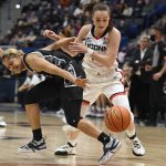 
              Connecticut's Nika Mühl steals the ball from Georgetown's Kaylin West, left, in the first half of an NCAA college basketball game, Sunday, Feb. 20, 2022, in Hartford, Conn. (AP Photo/Jessica Hill)
            