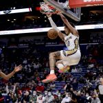
              New Orleans Pelicans center Jaxson Hayes (10) dunks next to Houston Rockets guard Josh Christopher (9) during the second half of an NBA basketball game in New Orleans, Tuesday, Feb. 8, 2022. (AP Photo/Derick Hingle)
            