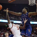 
              Texas guard Courtney Ramey (3) is blocked by Kansas forward David McCormack (33) during the second half of an NCAA college basketball game, Monday, Feb. 7, 2022, in Austin, Texas. (AP Photo/Eric Gay)
            