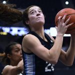 
              Villanova's Maddy Siegrist (20) pulls down a rebound in the first half of an NCAA college basketball game against Connecticut, Wednesday, Feb. 9, 2022, in Hartford, Conn. (AP Photo/Jessica Hill)
            