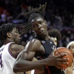 
              Rutgers center Clifford Omoruyi drives to the basket around Illinois forward Omar Payne (4) during the second half of an NCAA college basketball game Wednesday, Feb. 16, 2022, in Piscataway, N.J. (AP Photo/Adam Hunger)
            
