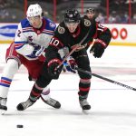 
              Ottawa Senators left wing Alex Formenton (10) tries to get to the puck past the stick of New York Rangers center Filip Chytil (72) during second-period NHL hockey game action in Ottawa, Ontario, Sunday, Feb. 20, 2022. (Justin Tang/The Canadian Press via AP)
            