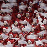 
              FILE - North Korean cheerleaders sing during the men's 500 meters short track speedskating semifinal in the Gangneung Ice Arena at the 2018 Winter Olympics in Gangneung, South Korea, on Feb. 22, 2018. North Korea basked in the global limelight during the last Winter Games in South Korea, with hundreds of athletes, cheerleaders and officials pushing hard to woo their South Korean and U.S. rivals in a now-stalled bid for diplomacy. Four years later, as the 2022 Winter Olympics come to its main ally and neighbor China, North Korea isn't sending any athletes and officials because of coronavirus fears. (AP Photo/David J. Phillip, File)
            