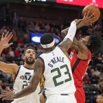 
              Houston Rockets guard Kevin Porter Jr., right, is fouled by Utah Jazz forward Royce O'Neale (23) as he goes to the basket during the first half of an NBA basketball game Monday, Feb. 14, 2022, in Salt Lake City. (AP Photo/Rick Bowmer)
            