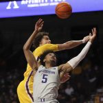 
              Northwestern guard Julian Roper II (5) and Minnesota guard Sean Sutherlin, top, go after a rebound ball during the first half of an NCAA college basketball game Saturday, Feb. 19, 2022, in Minneapolis. (AP Photo/Stacy Bengs)
            