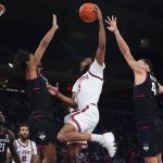 
              St. John's Aaron Wheeler, center, jumps to the basket during the second half of an NCAA college basketball game against Connecticut Sunday, Feb. 13, 2022, in New York. (AP Photo/Seth Wenig)
            