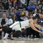 
              Boston Celtics forward Grant Williams (12) and Indiana Pacers forward Jalen Smith, top, dive for the ball during the second half of an NBA basketball game, Sunday, Feb. 27, 2022, in Indianapolis. (AP Photo/Darron Cummings)
            