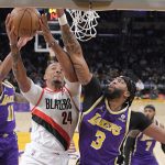 
              Portland Trail Blazers forward Norman Powell, center, shoots as Los Angeles Lakers guard Malik Monk, left, and forward Anthony Davis defend during the first half of an NBA basketball game Wednesday, Feb. 2, 2022, in Los Angeles. (AP Photo/Mark J. Terrill)
            