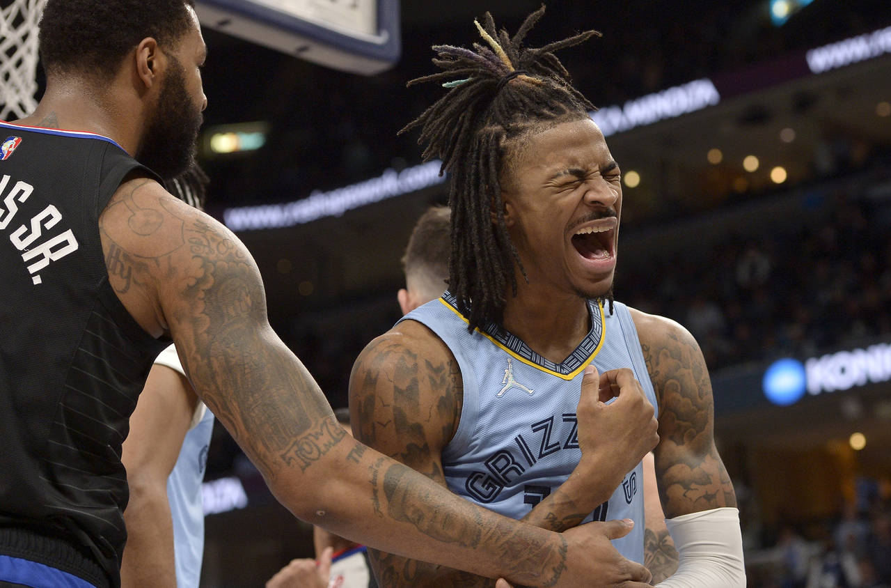 Memphis Grizzlies guard Ja Morant (12) reacts after being fouled by Los Angeles Clippers forward Ma...