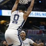 
              Memphis Grizzlies guard De'Anthony Melton (0) dunks the ball as guard Ziaire Williams, right, reacts during the second half of an NBA basketball game against the Orlando Magic, Saturday, Feb. 5, 2022, in Orlando, Fla. (AP Photo/John Raoux)
            