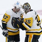 
              Pittsburgh Penguins center Sidney Crosby (87) congratulates goaltender Tristan Jarry after defeating the Boston Bruins 4-2 in an NHL hockey game, Tuesday, Feb. 8, 2022. (AP Photo/Charles Krupa)
            