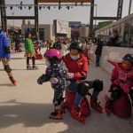 
              Residents bring their children play ice skating at a mall next to a venue which host the men's and women's ice hockey games at the 2022 Winter Olympics in Beijing, Thursday, Feb. 10, 2022. The possibility of a large outbreak in the Olympic bubble, potentially sidelining athletes from competitions, has been a greater fear than any leakage into the rest of China. (AP Photo/Andy Wong)
            
