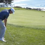 
              Tom Hoge hits onto the ninth green of the Pebble Beach Golf Links during the final round of the AT&T Pebble Beach National Pro-Am golf tournament in Pebble Beach, Calif., Sunday, Feb. 6, 2022. (AP Photo/Tony Avelar)
            