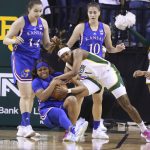 
              Baylor forward NaLyssa Smith, right, battles Kansas guard Chandler Prater, left, for a loose rebound in the first half of an NCAA college basketball game, Saturday, Feb. 26, 2022, in Waco, Texas. (AP Photo/Rod Aydelotte)
            