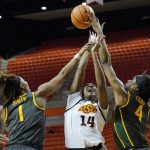 
              Baylor center Queen Egbo (4) blocks a shot by Oklahoma State forward Taylen Collins (14) as Collins shoots between Egbo and forward NaLyssa Smith (1) in the second half of an NCAA college basketball game Wednesday, Feb. 23, 2022, in Stillwater, Okla. (AP Photo/Sue Ogrocki)
            