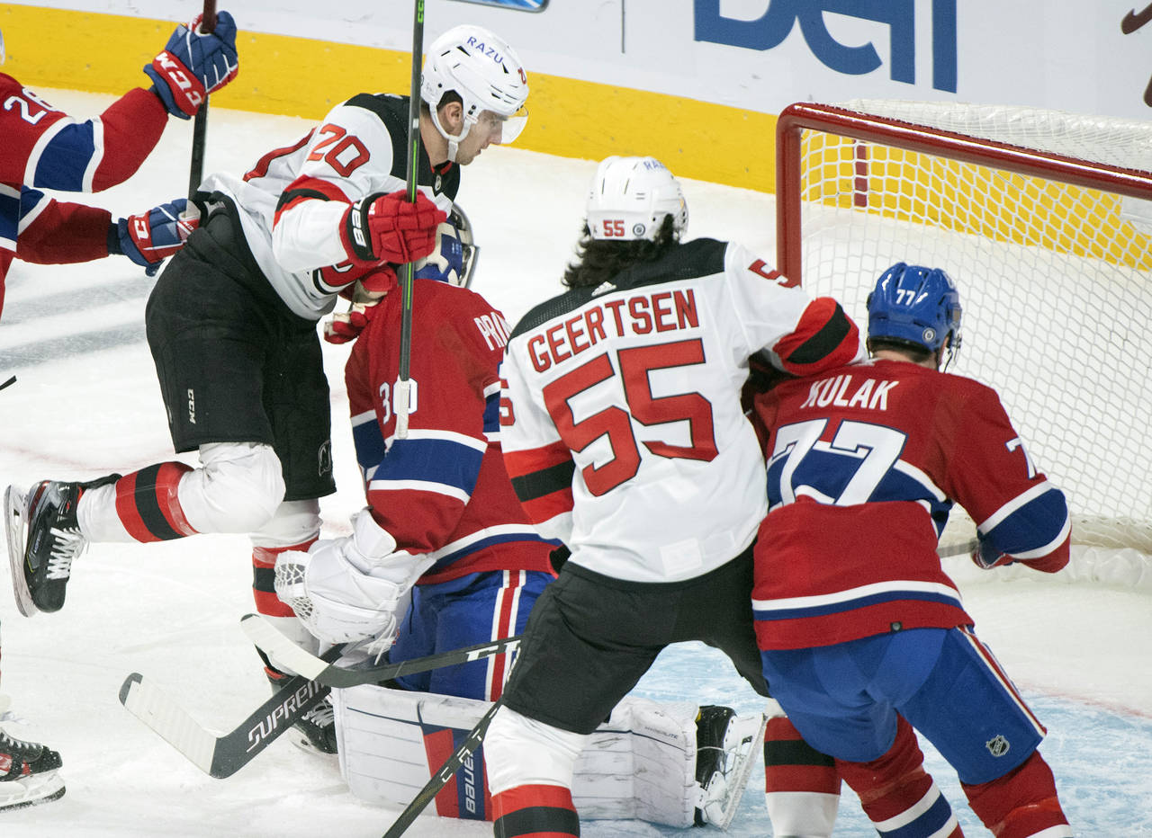 Montreal Canadiens goaltender Cayden Primeau is scored on by New Jersey Devils' Michael McLeod (20)...