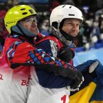 
              Bronze medal winner Ilia Burov, of the Russian Olympic Committee, left, hugs silver medal winner Ukraine's Oleksandr Abramenko as they celebrate after the men's aerials finals at the 2022 Winter Olympics, Wednesday, Feb. 16, 2022, in Zhangjiakou, China. (AP Photo/Gregory Bull)
            