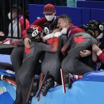 
              Team Canada celebrate after winning the men's 5000-meters relay final during the short track speedskating competition at the 2022 Winter Olympics, Wednesday, Feb. 16, 2022, in Beijing. (AP Photo/David J. Phillip)
            