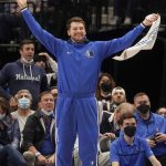 
              Dallas Mavericks guard Luka Doncic cheers from the sideline during the second half of an NBA basketball game against the Atlanta Hawks in Dallas, Sunday, Feb. 6, 2022. (AP Photo/LM Otero)
            