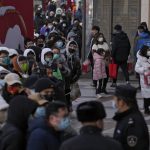 
              Hundreds of people line up to visit a store selling 2022 Winter Olympics memorabilia in Beijing, Monday, Feb. 7, 2022. The race is on to snap up scarce 2022 Winter Olympics souvenirs. Dolls of mascot Bing Dwen Dwen, a panda in a winter coat, sold out after buyers waited in line overnight in freezing weather. (AP Photo/Andy Wong)
            