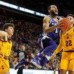 
              Kansas State guard Markquis Nowell, center, drives to the basket between Iowa State guard Caleb Grill, left, and guard Gabe Kalscheur, right, during the second half of an NCAA college basketball game, Saturday, Feb. 12, 2022, in Ames, Iowa. (AP Photo/Charlie Neibergall)
            
