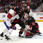 
              Ottawa Senators defenseman Artem Zub (2) uses his stick to force Montreal Canadiens center Rem Pitlick (32) out of the crease of goaltender Matt Murray (30) during the first period of an NHL hockey game Saturday, Feb. 26, 2022 in Ottawa, Ontario. (Justin Tang/The Canadian Press via AP)
            