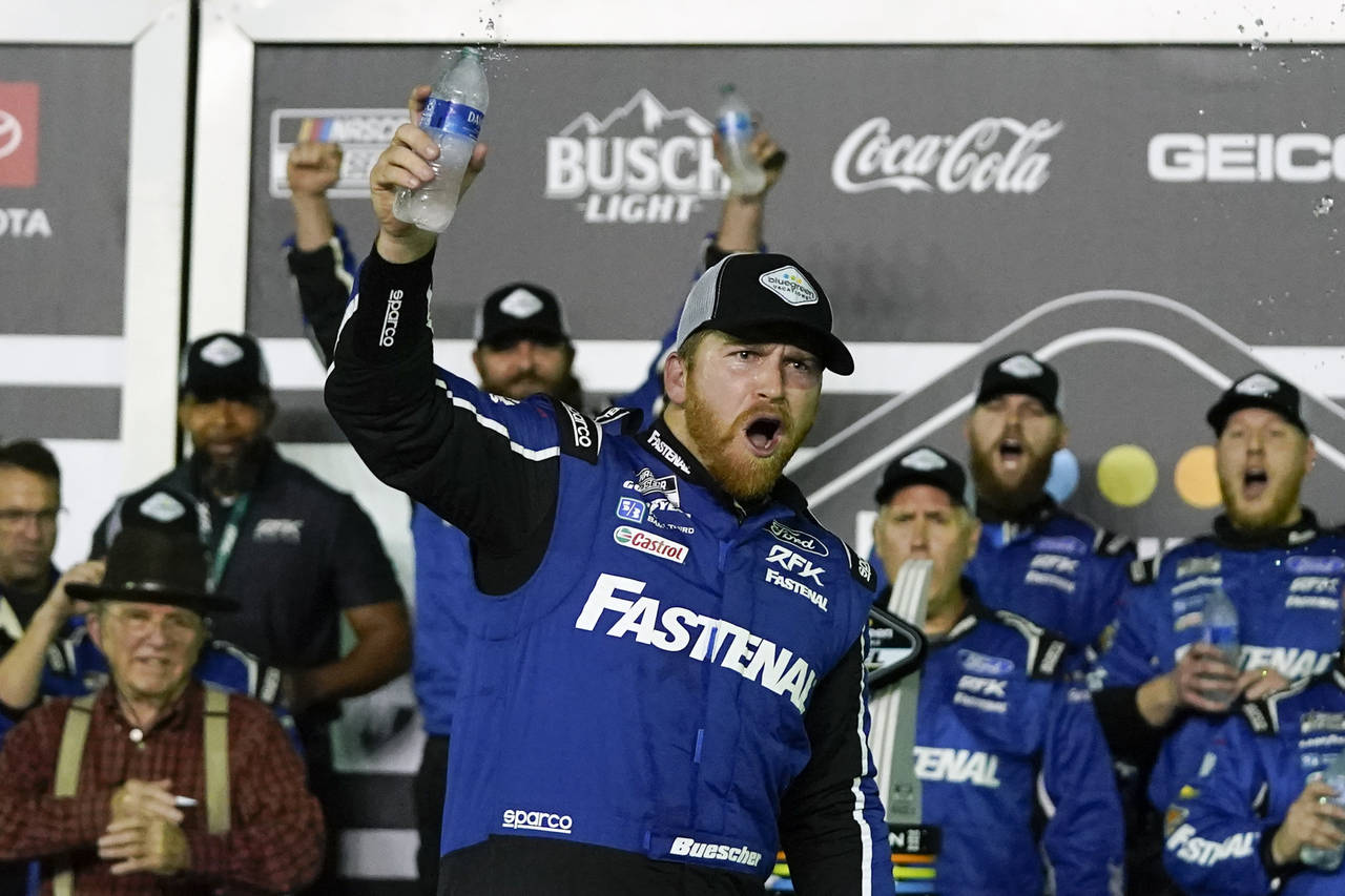 Chris Buescher, front, celebrates in Victory Lane with team members after winning the second NASCAR...