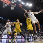 
              Penn State forward Seth Lundy (1) scores on a lay-up against Michigan during an NCAA college basketball game at the Bryce Jordan Center on Tuesday, Feb. 8, 2022 in State College, Pa. (Noah Riffe/Centre Daily Times via AP)
            