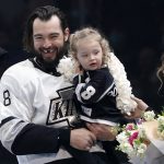 
              Los Angeles Kings defenseman Drew Doughty, left, stand with his daughter and wife, Nicole, prior to an NHL hockey game against the Edmonton Oilers Tuesday, Feb. 15, 2022, in Los Angeles as the Kings celebrated Doughty's 1,000th game, played on Jan. 27. (AP Photo/Mark J. Terrill)
            