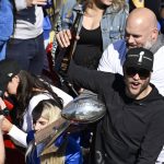 
              Los Angeles Rams quarterback Matthew Stafford holds up a bottle as offensive lineman Andrew Whitworth, right, holds the Vince Lombardi Super Bowl trophy during the team's victory parade in Los Angeles, Wednesday, Feb. 16, 2022, following their win Sunday over the Cincinnati Bengals in the NFL Super Bowl 56 football game. (AP Photo/Kyusung Gong)
            
