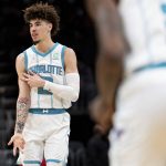 
              Charlotte Hornets guard LaMelo Ball (2) reacts after making a 3-pointer against the Toronto Raptors during the first half of an NBA basketball game in Charlotte, N.C., Monday, Feb. 7, 2022. (AP Photo/Jacob Kupferman)
            